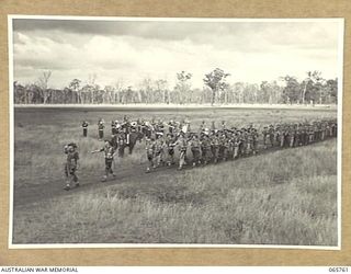 WONDECLA, QLD. 1944-04-15. MEMBERS OF "A" COMPANY, 2/1ST INFANTRY BATTALION GIVE "EYES RIGHT" AS THEY MARCH PAST THEIR COMMANDING OFFICER, NX163 LIEUTENANT COLONEL P.A. CULLEN, DSO. (1), WITH THE ..