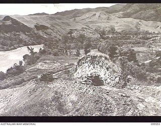 WAU-LABU ROAD, NEW GUINEA, 1946-01-09. TD18 VEHICLES OF 8 MECHANICAL EQUIPMENT COMPANY, ROYAL AUSTRALIAN ENGINEERS, WORKING ON THE SUNSHINE DEVIATION, SIXTY-TWO 62 MILES FROM LABU, LOOKING WESTWARD ..