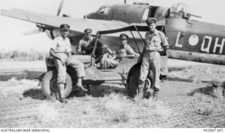 The crew of a Department of Aircraft Production (DAP) Beaufort bomber A9-557 in and beside a Jeep on the port side of their aircraft. Left to right: 422085 Flying Officer (FO, later Flight ..