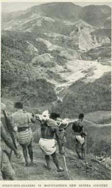 Stretcher-bearers in mountainous New Guinea country