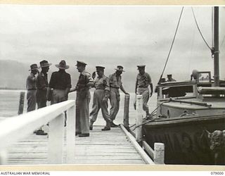 MALMAL VILLAGE, NEW BRITAIN. 1945-02-09. VISITING AUSTRALIAN GENERALS ALIGHTING FROM THE AM1439 THE LAUNCH OF THE GENERAL OFFICER COMMANDING, 5TH DIVISION, AT THE VILLAGE JETTY. VX19 MAJOR GENERAL ..