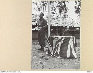 CAPE PUS, NEW GUINEA. 1945-11-03. CHAPLAIN N.D. WINN, 2/2 INFANTRY BATTALION, CONDUCTING THE MEMORIAL SERVICE FOR FALLEN COMRADES OF THE AITAPE-WEWAK CAMPAIGN