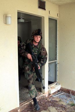 Marines from 31st Marine Expeditionary Unit (MEU), 2nd Battalion, 4th Marines, Fox Company, 3rd Platoon conduct Military Operations in Urban Terrain (MOUT) at an abandoned housing unit on Anderson Air Force Base (AFB), Guam in support of Exercise TANDEM THRUST 2003