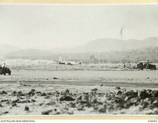 PAPUA. 1942-07-25. THIS MARAUDER (B26) BOMBER AIRCRAFT OF US AIR FORCE 22ND BOMB GROUP IS NOT AIR-BORNE, AS MIGHT APPEAR, BUT IS MAKING A FORCED LANDING ON AN AIRFIELD. NOTE THE CLOUD OF DUST ..
