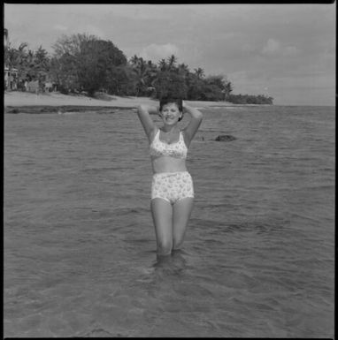 Miss Maglia wearing a bikini and standing in the sea at Suva, Fiji, 22 February 1966 [1] John Mulligan