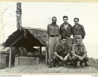 LAE, NEW GUINEA. 1944-04-01. PERSONNEL OF THE ROYAL AUSTRALIAN NAVY SIGNAL STATION AT HEADQUARTERS LAE ROYAL AUSTRALIAN NAVY PORT DIRECTORATE AT THE ENTRANCE TO SIGNAL STATION P.W.S.S. (PORT WAR ..