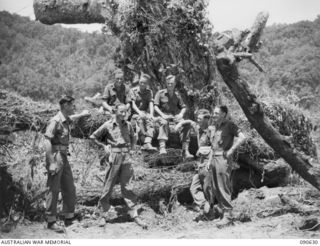 BUT, NEW GUINEA. 1945-04-10. HQ COMPANY, 2/8 INFANTRY BATTALION OFFICERS AT THEIR CAMP. IDENTIFIED PERSONNEL ARE:- LT F.G. CHAFFE (1); LT T.A.L. KERR (2); LT L.M. PENN- TONKIN (3); MAJ D. BRAHAM ..