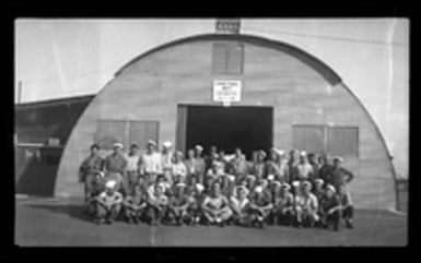 [Servicemen outside Quonset hut]