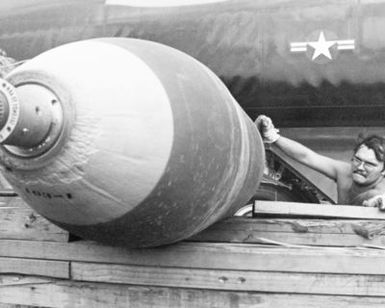 A munitions specialists prepares a bomb that will be used during LINEBACKER Operations over North Vietnam