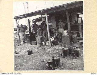 MOEM, WEWAK AREA, NEW GUINEA, 1945-09-17. MEMBERS OF 2/4 ARMOURED REGIMENT DETACHMENT WITH 4 INFANTRY TROOPS WORKSHOP, WORKING IN THE KITCHEN