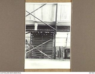 PORT MORESBY, NEW GUINEA. 1943-12-06. VIEW SHOWING THE METHOD USED TO JOIN TWO "ARMCO" STORAGE HUTS TOGETHER AT NO. 2 SUB DEPOT, 10TH AUSTRALIAN ADVANCED ORDNANCE DEPOT