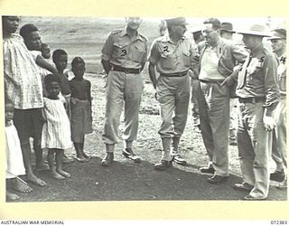 BISIATABU, NEW GUINEA. 1944-04-19. THE HONOURABLE E.J. WARD, MINISTER FOR EXTERNAL TERRITORIES IN THE AUSTRALIAN GOVERNMENT (1), WITH THE WIVES AND CHILDREN OF MEMBERS OF THE ROYAL PAPUAN ..