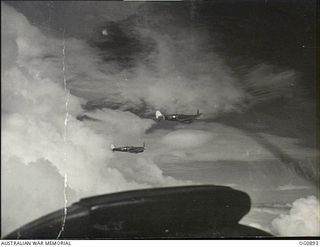 BISMARCK ARCHIPELAGO. 1944-03-28. AIRCRAFT, CODE NAMED UP-C, UP-W, OF NO. 79 (SPITFIRE) SQUADRON RAAF, IN FLIGHT OVER NEW BRITAIN EN ROUTE FROM KIRIWINA TO THE ADMIRALTY ISLANDS. PHOTOGRAPH TAKEN ..