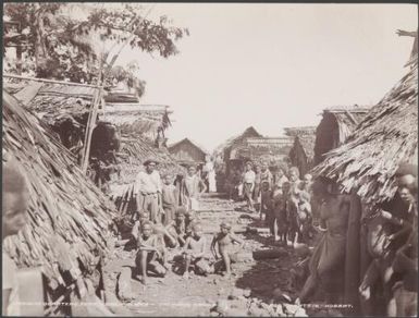 Local people gathered near the womens quarters of Ferasiboa, Malaita, Solomon Islands, 1906 / J.W. Beattie