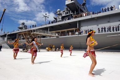 Polynesian dancers greet the officers and crew of the US Navy (USN) Amphibious Command Ship USS BLUE RIDGE (LCC 19) to the tropical island of Saipan. The BLUE RIDGE is on a four-day port visit coinciding with local Veteran's Day ceremonies. The BLUE RIDGE is the Seventh Fleet command and control ship, forward deployed to Yokosuka, Japan