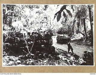 GODOWA, NEW GUINEA. 1943-11-05. A JEEP NEGOTIATING A BAD STRETCH OF MUDDY ROAD NEAR THE 9TH AUSTRALIAN DIVISION HEADQUARTERS