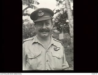 MILNE BAY, PAPUA NEW GUINEA. C. 1943-10-30. INFORMAL PORTRAIT OF FLYING OFFICER GILMAN, NO. 6 (BEAUFORT) SQUADRON RAAF, A RAAF OBSERVER IN NEW GUINEA, SHOWING THAT PILOTS ARE NOT THE ONLY RAAF ..