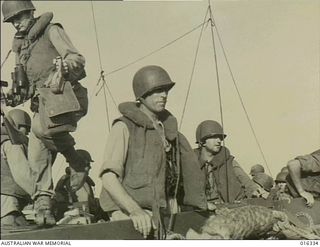 New Britain. 15 December 1943. As Allied landing craft approach the southern coast near Arawe at dawn, American troops scan the shores in an endeavour to locate enemy strongpoints. Our air assaults ..