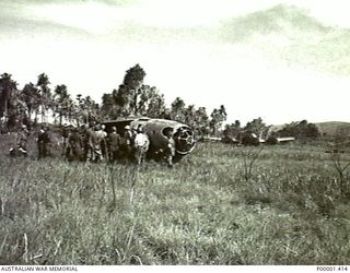 NEW IRELAND, 1945-10. ALLIED AND JAPANESE SERVICE PERSONNEL EXAMINE THE REMAINS OF A WRECKED MITSUBISHI G4M1 "BETTY" BOMBER AIRCRAFT. ANOTHER G4M1 LIES IN THE BACKGROUND. (RNZAF OFFICIAL ..