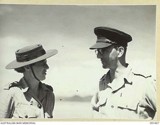 LAE, NEW GUINEA, 1945-05-07. LIEUTENANT-COLONEL W.E. HOLMES, OFFICER COMMANDING TROOPS ABOARD THE MV DUNTROON (1), A POSITION HE HAS HELD FOR 2 1/2 YEARS, DISCUSSING DISEMBARKATION ARRANGEMENTS ..