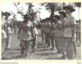 LAE, NEW GUINEA. 1945-10-22. PRIVATE P. CURRAN, PRIVATE W. HARRIS, PRIVATE E. BILLSON AND PRIVATE J. CURTIS, AUSTRALIAN WOMEN'S ARMY SERVICE PERSONNEL ON PARADE, STANDING TO ATTENTION FOR ..