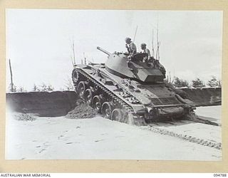 TOROKINA AREA, BOUGAINVILLE, 1945-08-06. AN M24 GENERAL CHAFFEE LIGHT TANK FAILING TO NEGOTIATE A THREE FOOT SAND BANK, OWING TO LACK OF TORQUE, DURING TRIALS CONDUCTED FOR THE WAR OFFICE