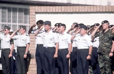 Military personnel render a salute as the remains of 27 service members missing in action are brought home after being returned in the largest turnover of MIAs since meetings began with North Vietnam in 1981