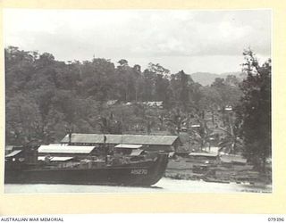 WUNUNG PLANTATION, NEW BRITAIN. 1945-02-27. PART OF A PANORAMA OF THE PLANTATION AREA SHOWING THE ASSISTANT DIRECTOR OF ORDNANCE SERVICES DUMP AND THE DETAILS ISSUING DEPOT STORES. JOINS ..