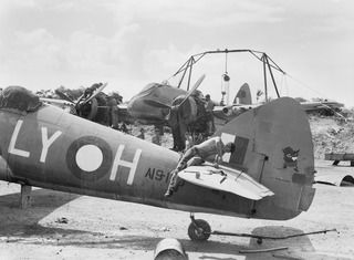 VIVIGANI, GOODENOUGH ISLAND, PAPUA. 1943-12-26. A BEAUFIGHTER BOMBER AIRCRAFT, CODED LY-H WITH ARTWORK ON THE TAIL, BEING OVERHAULED BY A SERVICING PARTY OF NO. 30 (BEAUFIGHTER) SQUADRON RAAF. A ..