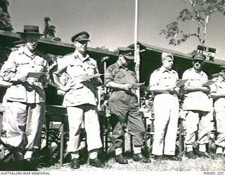 THE SOLOMON ISLANDS, 1945-08. SERVICE OFFICERS AND BRITISH ENTERTAINER GRACIE FIELDS AT A THANKSGIVING SERVICE ON BOUGAINVILLE ISLAND. (RNZAF OFFICIAL PHOTOGRAPH.)