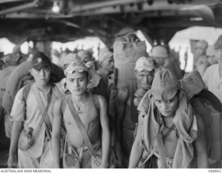 RABAUL, NEW BRITAIN, 1946-02-28. FORMOSAN AND KOREAN TROOPS LEAVING THE DEMILITARIZED JAPANESE AIRCRAFT CARRIER KATSURAGI TO MAKE ROOM FOR THE FIRST DRAFT OF JAPANESE TROOPS TO BE RETURNED TO THEIR ..