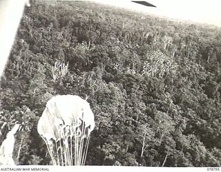 PEARL RIDGE AREA, BOUGAINVILLE ISLAND. 1945-01-30. PERSONNEL OF THE SOLOMON'S DETACHMENT, 12TH AIR MAINTENANCE PLATOON (TS), 4TH BASE SUB AREA, DROPPING SUPPLIES FROM ONE OF THEIR AIRCRAFT TO ..