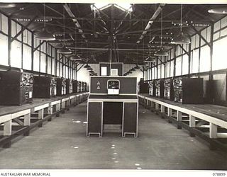 LAE, NEW GUINEA. 1945-02-06. THE INTERIOR OF THE WIRELESS TRANSMITTING CENTRE OF THE 19TH LINES OF COMMUNICATION SIGNALS, HEADQUARTERS, FIRST AUSTRALIAN ARMY, SHOWING SOME OF THE 17- 133 ..