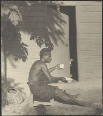 Aiau scraping coconut, Rabaul, New Guinea, ca. 1936 / Sarah Chinnery