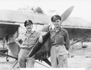 AITAPE, NORTH EAST NEW GUINEA. 1945-05-01. AUSTER AIR AMBULANCE PILOTS FLYING OFFICER JOHN RUSH OF EARLWOOD, NSW, AND BERT PAINE OF ARMIDALE, NSW, BESIDE THEIR MIDGET AIRCRAFT ON TADJI AIRFIELD