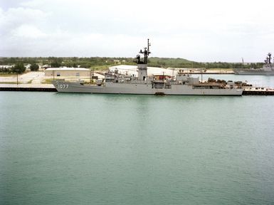 A port beam view of the frigate USS QUELLET (FF 1077) moored in the harbor