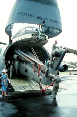 A 53rd Aviation Battalion UH-60 Black Hawk helicopter is offloaded from a Military Airlift Command C-5 Galaxy aircraft at Faleolo International Airport. The helicopter will be used by U.S. military personnel during disaster relief efforts on the islands of Upolu and Savaii in the aftermath of Cyclone Ofa