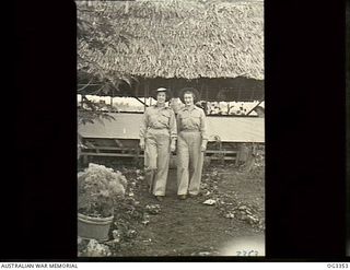 MADANG, NEW GUINEA. C. 1945. SENIOR SISTER E. DOHERTY (LEFT) AND SISTER P. SCHOLES OF SYDNEY, NSW, LEAVE THEIR MESS TO GO ON NIGHT DUTY AT NO. 1 MEDICAL RECEIVING STATION RAAF