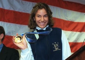 Olympic gold medalist Sara DeCosta (goalie, ice hockey) holds up her gold medal during the press conference at Green Airport after she arrived on a United Airlines flights on her return from Hawaii