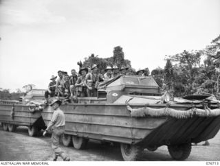 MILFORD HAVEN, LAE, NEW GUINEA. 1944-11-01. TROOPS OF THE 4TH FIELD REGIMENT ABOARD AN AMERICAN ARMY AMPHIBIOUS DUKW READY FOR TRANSPORT OUT TO THE LIBERTY SHIP, LINDLEY M. GARRISON, FOR THE UNIT ..