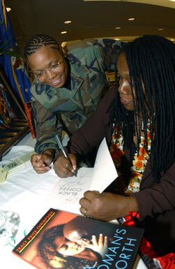 Author Tracy Price-Thompson (right) signs a book for 1ST LT. Joy Morgan during the Black History Month Luncheon at the Tradewinds Enlisted Club at Hickam Air Force Base, Hawaii, on Feb. 4, 2005. (PHOTO by Angela Elbern, CIV) (Released)