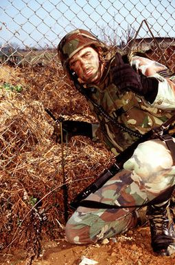 STAFF SGT. Charles Allen, 15th Security Police Squadron, Hickam AFB, Hawaii, checks to see that the base intrusion sensors are properly positioned to detect intruders during the exercise.(Exact date unknown)
