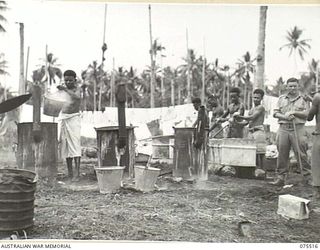 MADANG, NEW GUINEA. 1944-08-25. NEW GUINEA NATIVES DOING THE UNIT WASHING IN THE LINES OF THE 2/11TH GENERAL HOSPITAL UNDER THE SUPERVISION OF VX5901 SERGEANT LM. YOUNG (1)