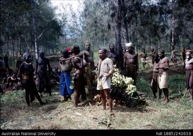 Men standing with fruit