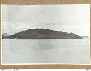 NAPA NAPA, NEW GUINEA. 1943-11-12. PAGA HILL AND PAGA POINT WITH PORT MORESBY ON THE EXTREME LEFT. BUILDINGS ON THE RIGHT HAND SIDE OF THE HILL ARE ARMY INSTALLATIONS