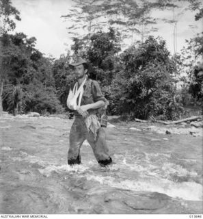 Walking wounded crossing the river. QX10087 Corporal (later Sergeant) Cyril George Harris, 2/25 Battalion returning to a dressing station
