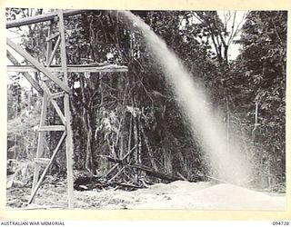 YALU AREA, NEW GUINEA, 1945-07-30. THE SAW DUST CONVEYOR AT NO. 2 PLATOON SAWMILL, 2/1 FORESTRY COMPANY, ROYAL AUSTRALIAN ENGINEERS, PHOTOGRAPHED AT THE REQUEST OF THE COMMANDING OFFICER