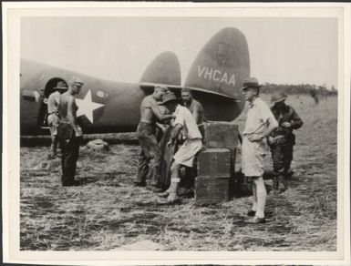 Hudson Fysh standing near a Lockheed Lodestar, VH-CAA, Poppondetta, New Guinea, ca. 1945