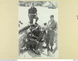 KOMANA POINT, NEW GUINEA. 1944-07-30. PERSONNEL OF D COMPANY, 30TH INFANTRY BATTALION, INSPECTING A 3" MORTAR AND EMPLACEMENT IN THE COMPANY AREA. IDENTIFIED PERSONNEL ARE:- NX112696 CAPTAIN R.F. ..