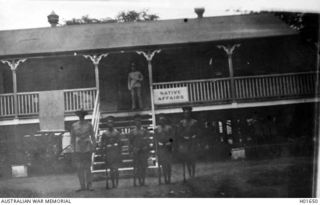 RABAUL, NEW BRITAIN. C. 1916. THE NATIVE AFFAIRS OFFICE BUILDING. THE FOUR ARMED NATIVES GUARDED THE AREA AT NIGHT